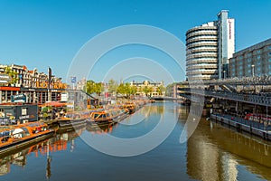 Amsterdam canal, cruise boats and bicycle parking, central train station area, North Holland, Netherlands, transport, traveling