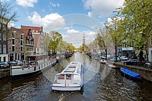 Amsterdam canal cruise ship with Netherlands traditional house i