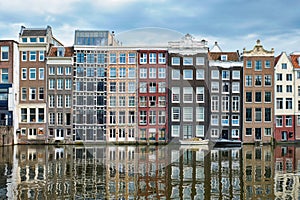 Amsterdam canal Damrak with houses, Netherlands