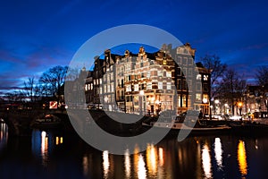 Amsterdam canal houses illuminated at dusk