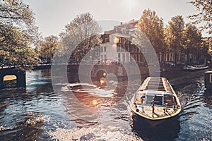 Amsterdam canal with tourist boat