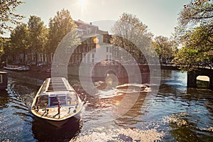 Amsterdam canal with tourist boat