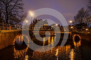 Amsterdam canal at twilight in winter, Amsterdam is the capital and most populous city in Netherlands