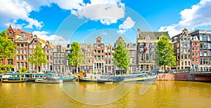 Amsterdam city skyline, colorful houses over Singel canal, Netherlands