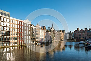 Amsterdam city view of Netherlands traditional houses with Amstel river in Amsterdam, Netherlands