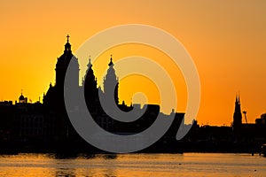 Amsterdam cityscape skyline with Church of Saint Nicholas Sint-Nicolaaskerk during sunset. Picturesque of Amsterdam, Netherlands.