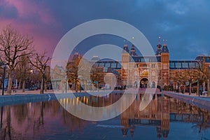 Amsterdam in a cold night during spring season. Famous national Rijks museum general view reflecting in tha water at dusk