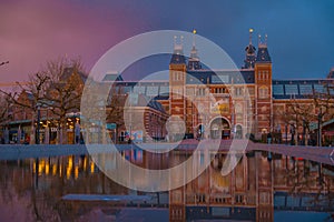 Amsterdam in a cold night during spring season. Famous national Rijks museum general view reflecting in tha water at dusk