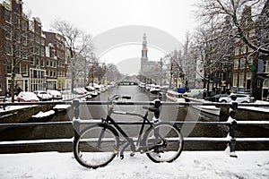 Amsterdam covered with snow with the Westerkerk in Netherlands