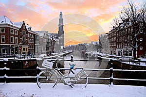 Amsterdam covered with snow with the Westerkerk in the Netherlands photo