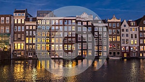 Amsterdam Damrak canal houses in blue hour