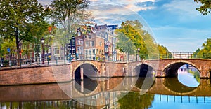 Amsterdam Downtown. Beautiful sky of dawn, old houses, canals and bridges. Heart of Amsterdam