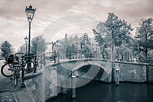 Amsterdam Downtown. The famous sloping houses of Amsterdam. Nice view with canals and bridges. Vintage toning. Amsterdam, Holland