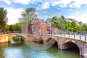 Amsterdam, with flowers and bicycles on the bridges over the canals, Holland, Netherlands.