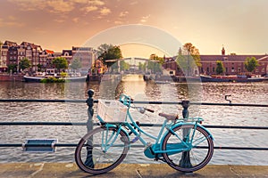 Amsterdam, with flowers and bicycles on the bridges over the canals, Holland, Netherlands.