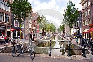 Amsterdam, with flowers and bicycles on the bridges over the canals, Holland, Netherlands.