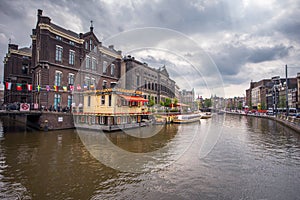 Amsterdam, with flowers and bicycles on the bridges over the canals, Holland, Netherlands.