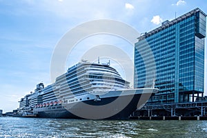 Amsterdam harbor. Line Cruise Ship docked at Holland Netherlands terminal. Cloudy blue sky