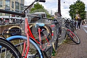 Amsterdam, Holland. August 2019. Bicycles parked along the canals are a symbol of the city. A bike with a red racing frame stands