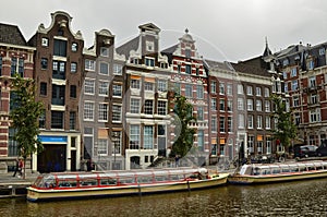 Amsterdam, Holland. August 2019. The large tourist boats that crowd the canals of the historic center: they move all day