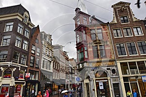 Amsterdam, Holland, August 2019. Rainy day in the old town. Among the typical little houses, a corner with a red bay window