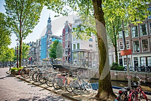 Amsterdam in Holland with its magnificent brunch breakfast canals, its levi barge bridge and traditional boat, flowery city bike