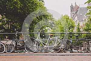 Amsterdam, Holland, May 12 2018: Old bicycle parked on a canal bridge in Amsterdam