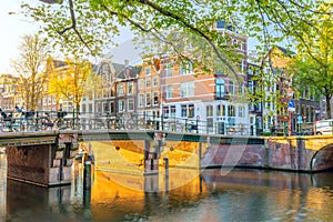 Amsterdam in the morning sun. Traditional old houses and bridges. Beautiful morning in Amsterdam