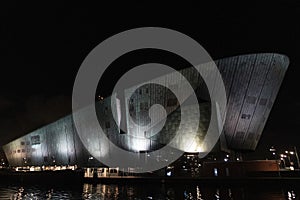 Amsterdam NEMO museum at night canal view