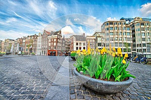 AMSTERDAM, THE NETHERLANDS - APRIL 25, 2015: Tourists and locals wlak along the city streets photo