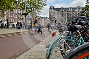 Amsterdam, the Netherlands, August 2019. Bikes parked on the sidewalk in the historic center: they are a city corner. The frames
