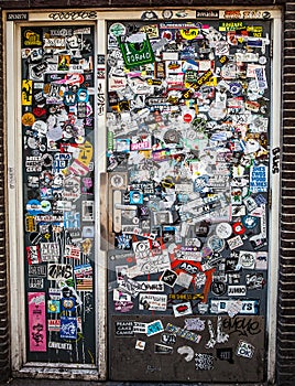 AMSTERDAM, NETHERLANDS - AUGUST 15, 2016: Street wall covered numerous multicolored stickers on August 15 in Amsterdam