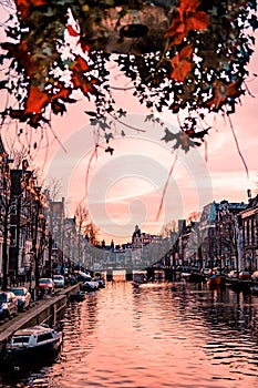 Amsterdam Netherlands Beautiful Groenburgwal canal in Amsterdam with the Soutern church Zuiderkerk at sunset