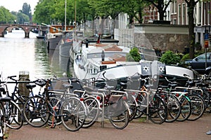 Amsterdam, The Netherlands, city canals, boats, bridges and streets. Unique beautiful and wild European city.