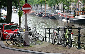 Amsterdam, The Netherlands, city canals, boats, bridges and streets. Unique beautiful and wild European city.