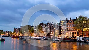 Amsterdam Netherlands city skyline day to night time lapse at canal waterfront