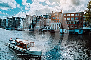 Amsterdam Netherlands dancing houses over river Amstel landmark in old european city landscape. Picturesque clouds on