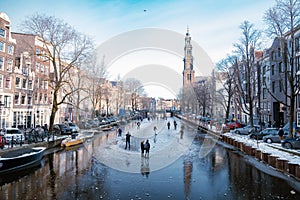 Ice skating on the canals in Amsterdam the Netherlands in winter, frozen canals in Amsterdam during winter