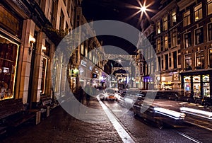 AMSTERDAM, NETHERLANDS - JANUARY 22 2016: City streets of Amsterdam at night. General views of city landscape on January 22, 2016