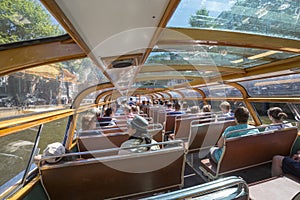 Tourists inside the pleasure boat in Amsterdam