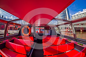 AMSTERDAM, NETHERLANDS, MARCH, 10 2018: Indoor view of red excursion boat or cruise ship on Amsterdam water canal in the