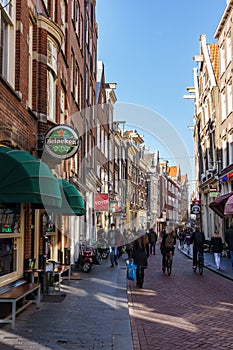 AMSTERDAM, NETHERLANDS - March 20, 2018 : narrow streets of Amsterdam at sunny spring day.