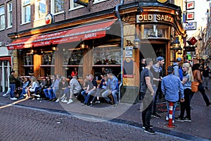 Tourists and local people enjoy the datch pub in red light district, Amsterdam, Netherlands