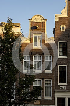 AMSTERDAM, NETHERLANDS - Sep 22, 2020: Traditional Dutch canal home facade in The Netherla