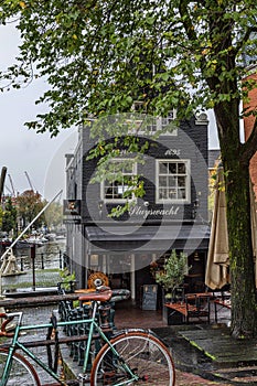 Amsterdam, Netherlands, 10/12/2019: Typical Dutch canal house with bridge and parked bike