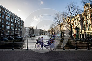 Amsterdam, The Netherlands, with water canals houses and crazy bike with flowers