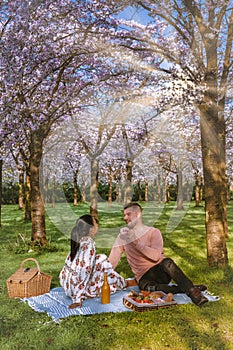 Amsterdam Netherlands, young couple picnic in empty park Amsterdamse Bos Bloesempark Netherlands, men and woman mid age