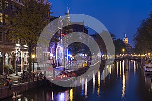 Amsterdam. Night view of Amsterdam cityscape with canal, bridge and typical Dutch Houses. Netherlands