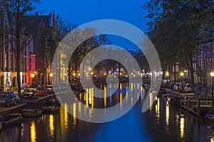 Amsterdam. Night view of Amsterdam cityscape with canal, bridge and typical Dutch Houses. Netherlands