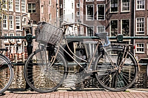 Amsterdam with old bikes on the bridge in Holland